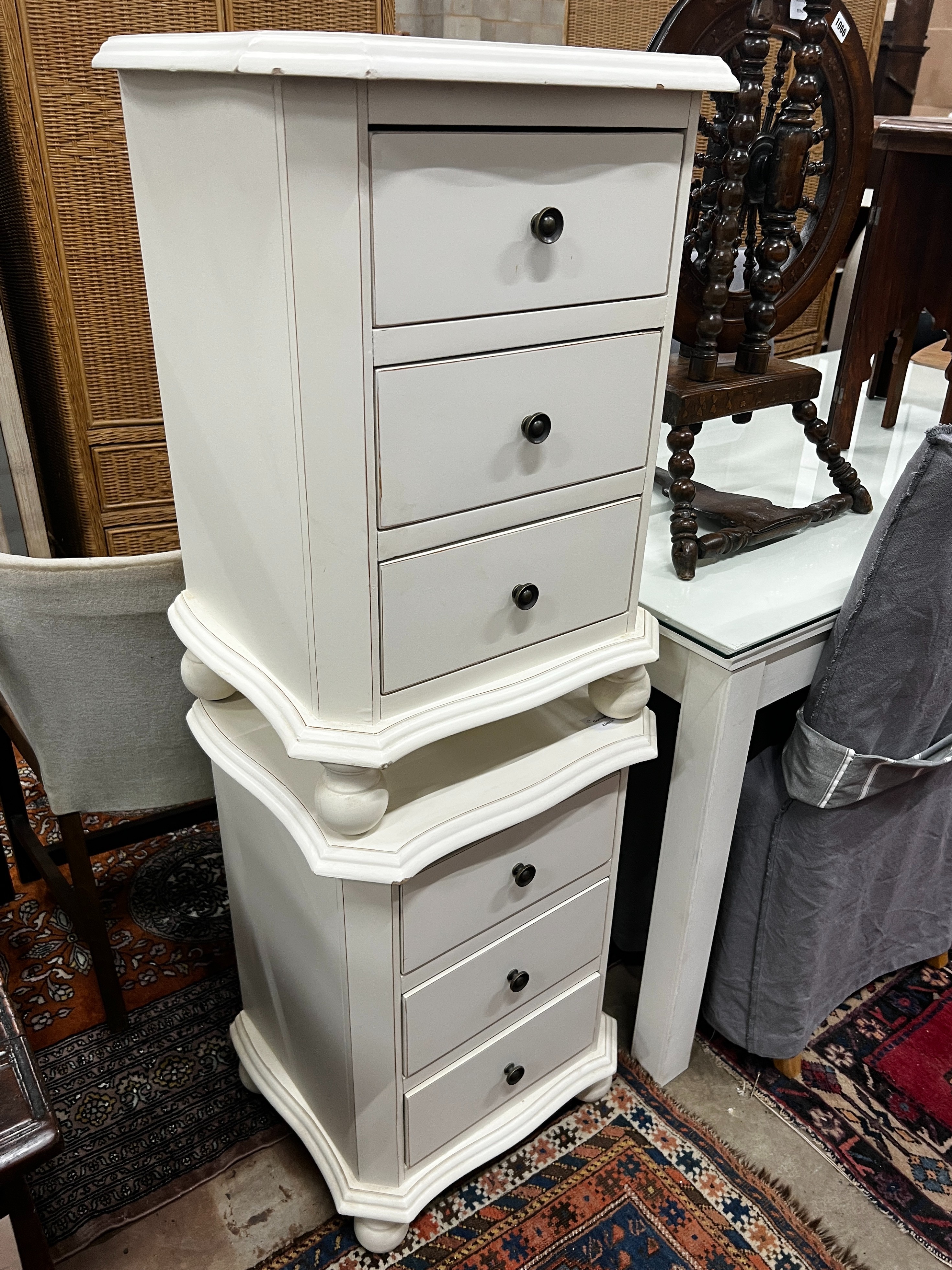 A pair of painted serpentine front three drawer bedside chests, width 45cm, depth 38cm, height 65cm